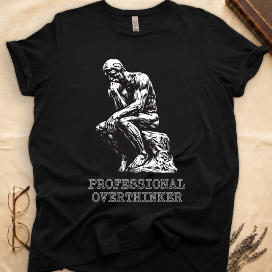 Black tee with monochrome rendering of Rodin's Thinker, "PROFESSIONAL OVERTHINKER" in serif capitals below.
