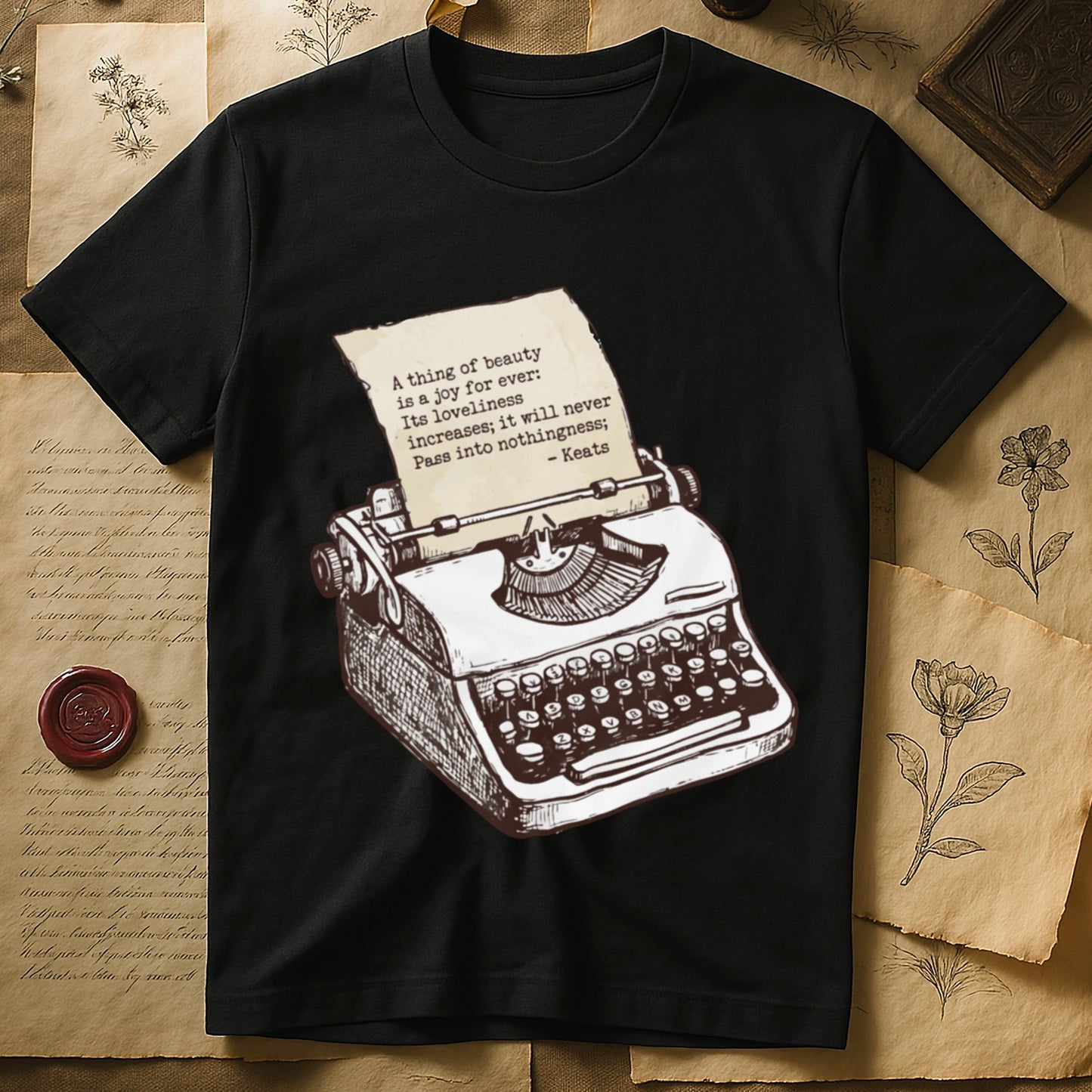 Black tee with vintage typewriter in cream linework, paper showing "A thing of beauty is a joy for ever" by Keats.