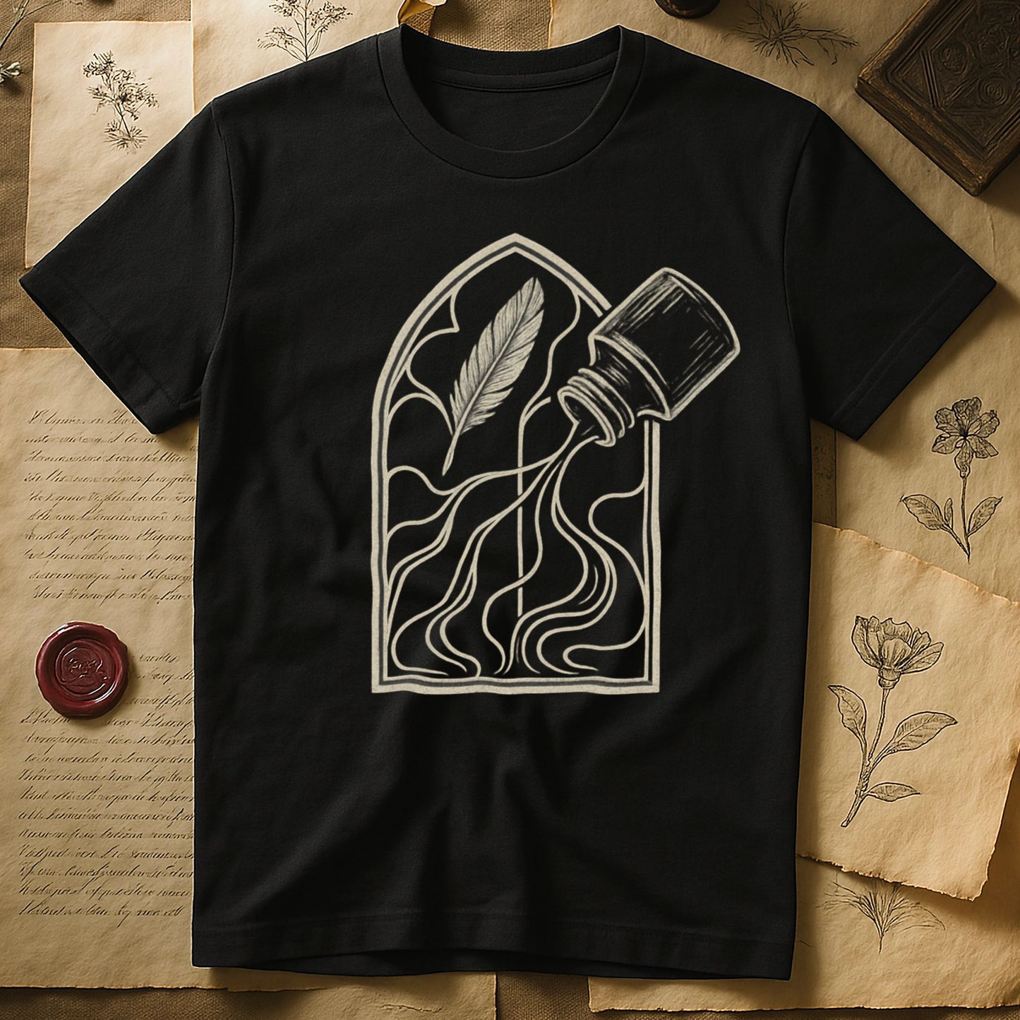 Black tee with sepia gothic arch, feather quill on left and tipped ink bottle on right spilling ink in curling tendrils.