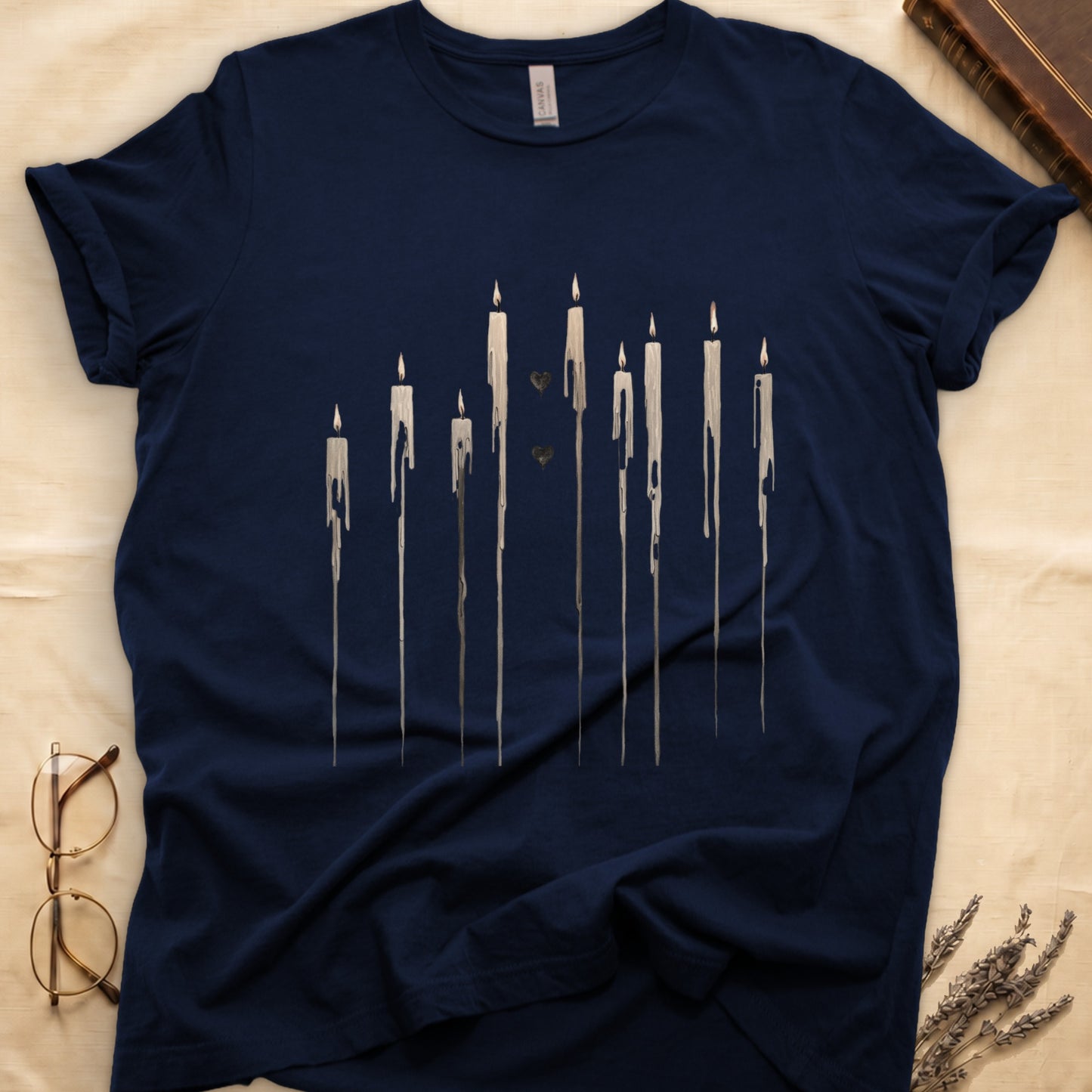 Dark navy t-shirt with a minimalist dripping candle design and two small hearts.