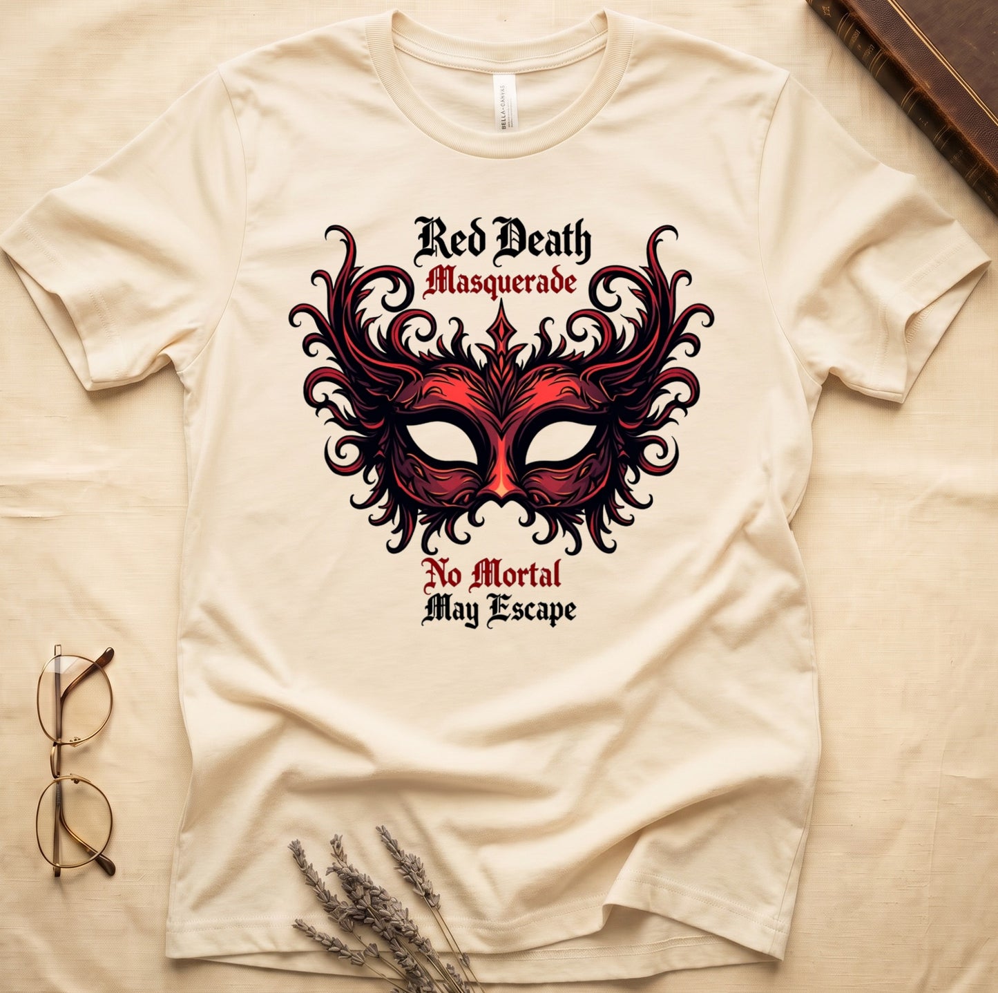 Natural tee with ornate red masquerade mask, flame scrollwork, "Red Death Masquerade" top, "No Mortal May Escape" below.