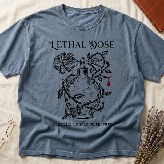 Blue Jean tee with cracked perfume bottle wrapped in thorns, blood drop, "LETHAL DOSE" top, "Fragile: Handle with care" below.