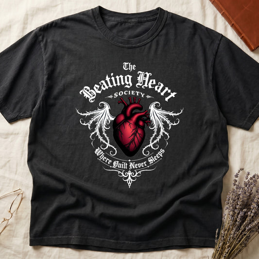 Black tee with anatomical red heart, gothic wings, "The Beating Heart SOCIETY," "Where Guilt Never Sleeps" below.