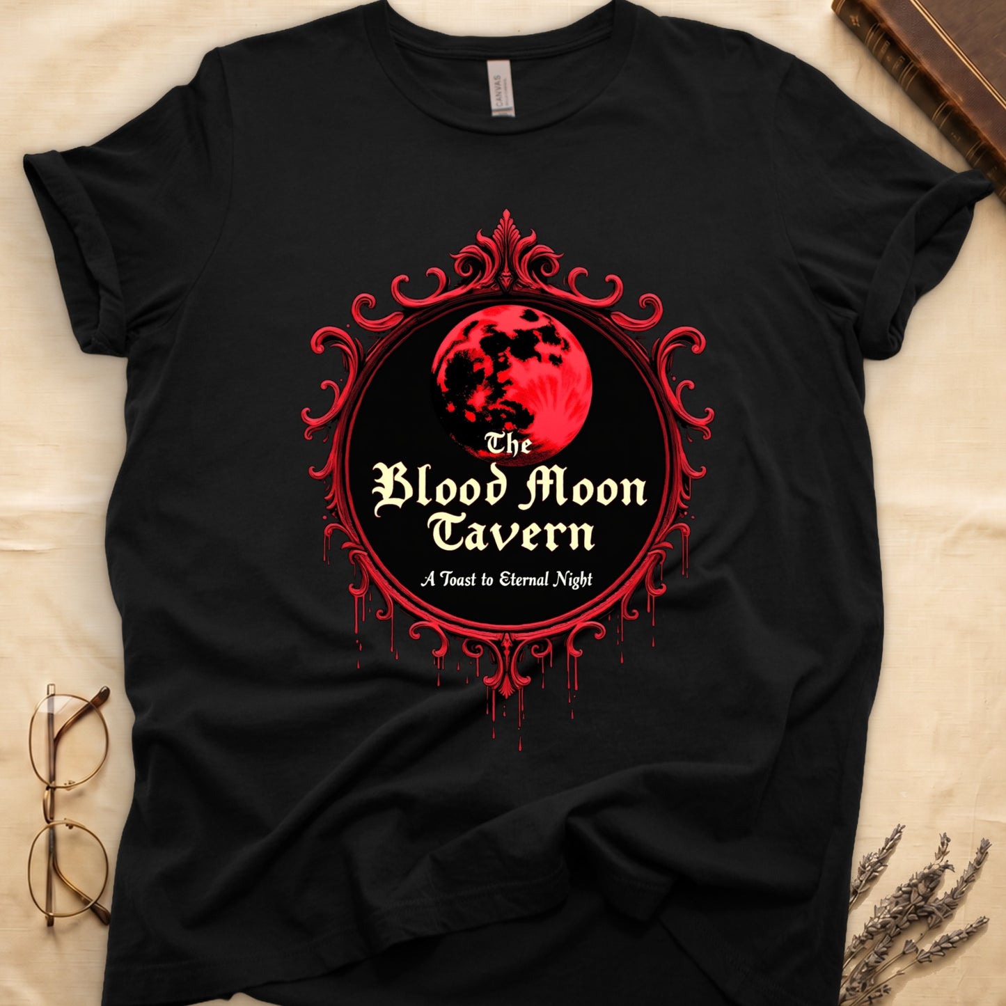 Black tee with red oval frame, blood-red moon, "The Blood Moon Tavern," "A Toast to Eternal Night," red drips below.