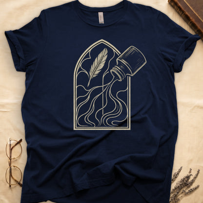 Navy tee with sepia gothic arch, feather quill on left and tipped ink bottle on right spilling ink in curling tendrils.