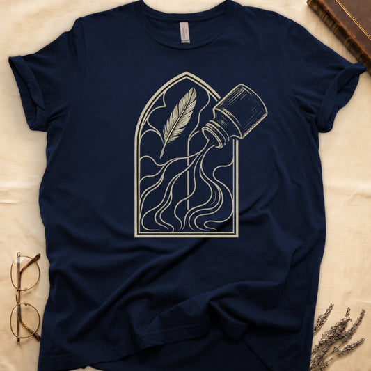 Navy tee with sepia gothic arch, feather quill on left and tipped ink bottle on right spilling ink in curling tendrils.