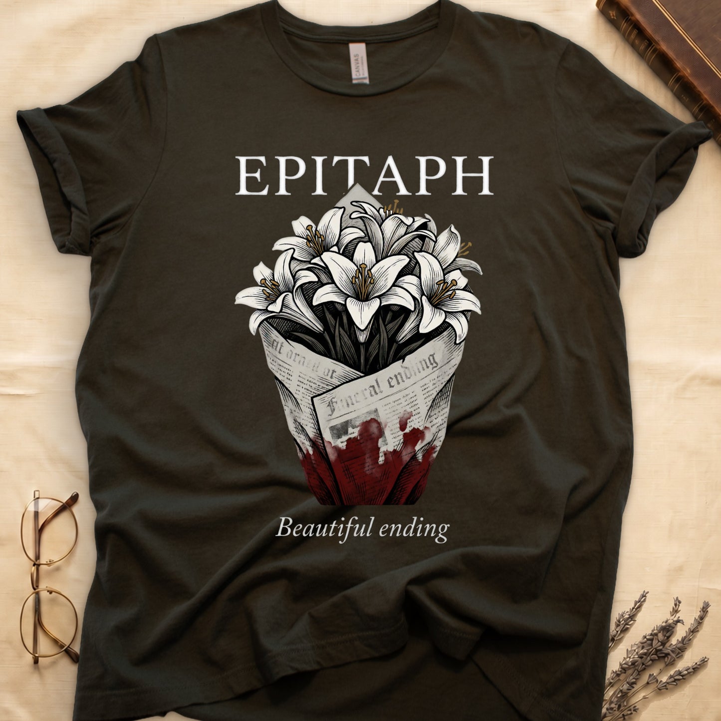 Military Green tee with "EPITAPH" over crosshatched white lilies in blood-stained newsprint wrap, "Beautiful ending" italic serif.