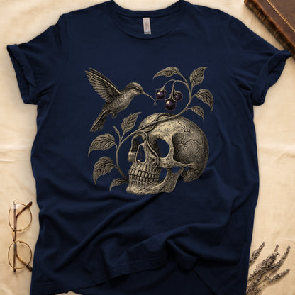 Navy tee with sepia engraved skull, nightshade vine and dark-purple berries wrapping around, hummingbird at upper left.