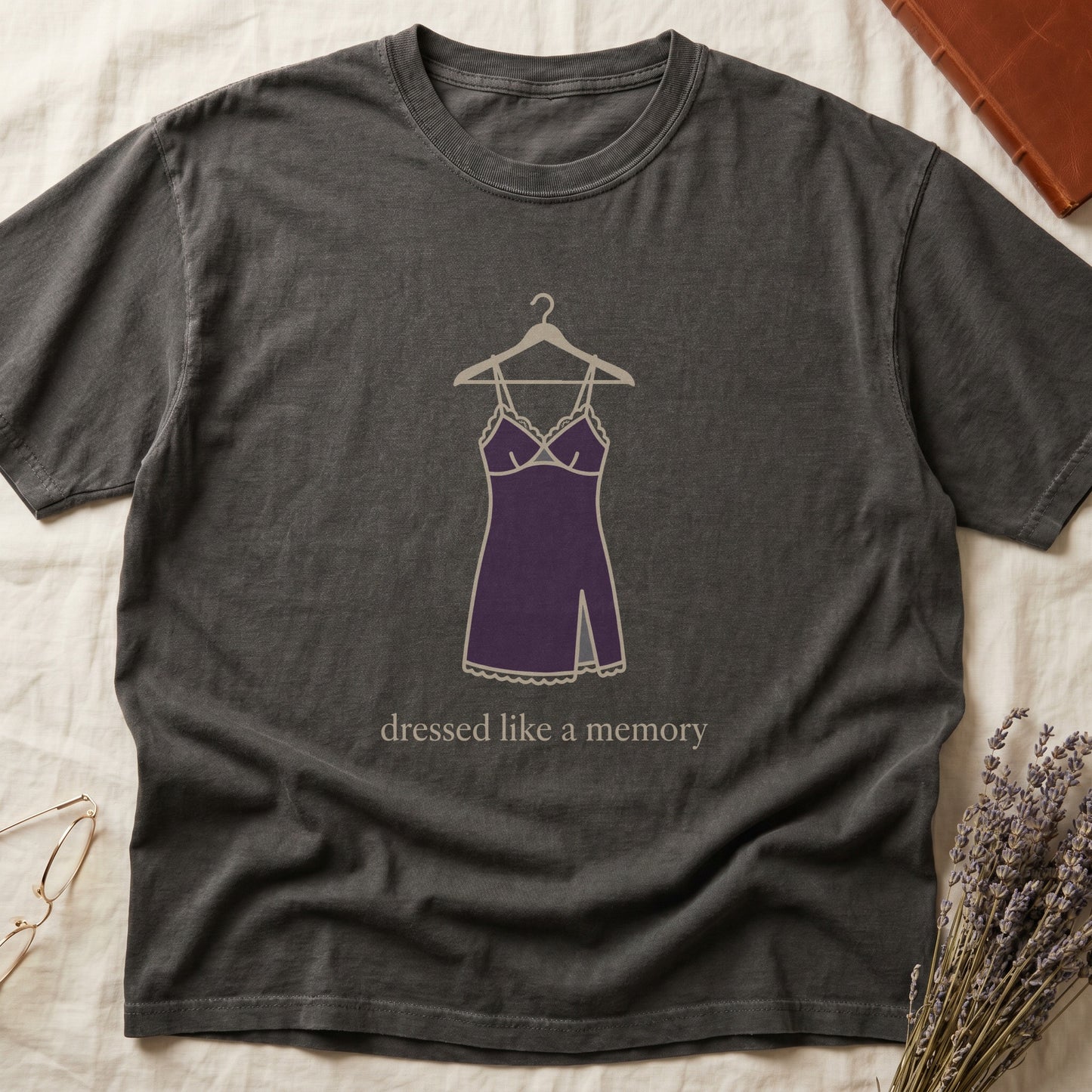 Pepper tee with dusty plum slip dress on cream hanger and "dressed like a memory" in lowercase cream serif below.