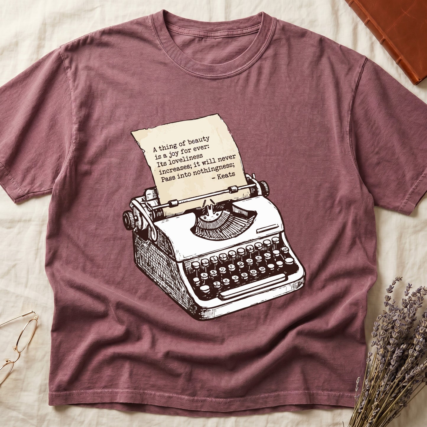 Dark Rose tee with vintage typewriter in cream linework, paper showing "A thing of beauty is a joy for ever" by Keats.