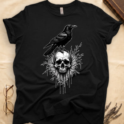 Black tee with raven silhouette on human skull, ink drips from jaw, bare branches behind, monochrome illustration.