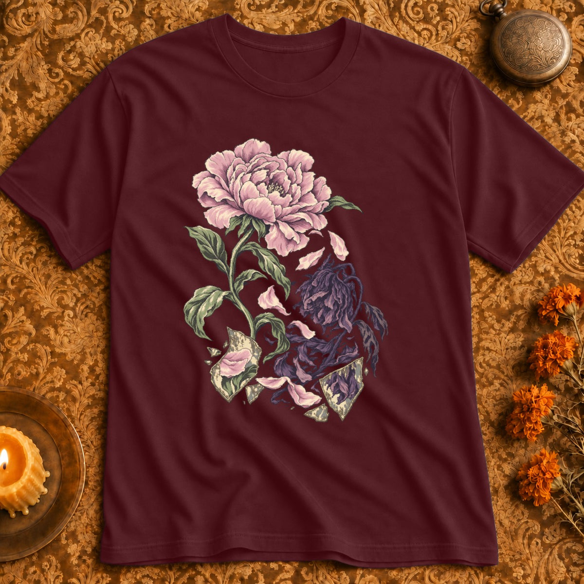 Maroon t-shirt with a cracked flower graphic in pink and dark purple.