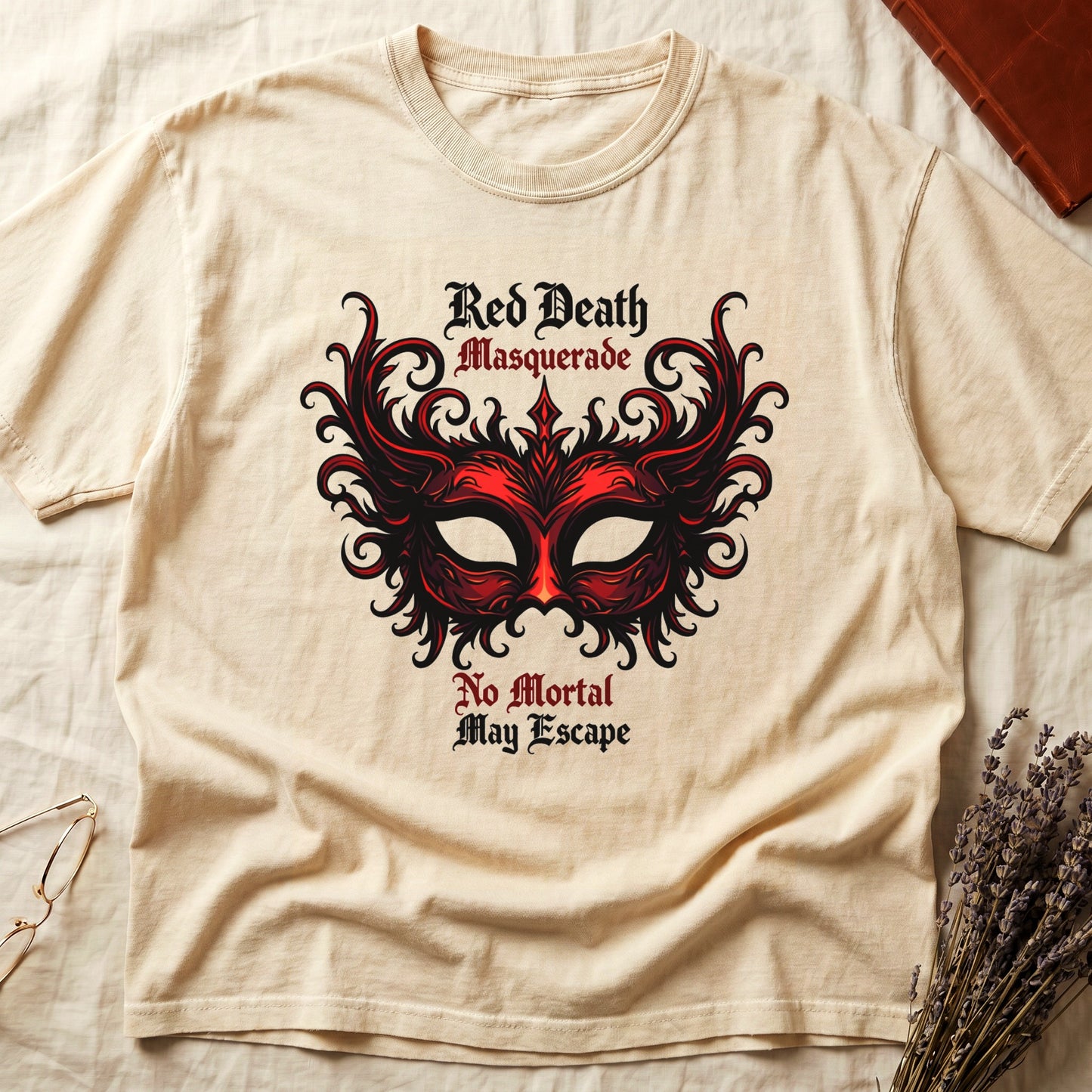 Ivory tee with ornate red masquerade mask, flame scrollwork, "Red Death Masquerade" top, "No Mortal May Escape" below.