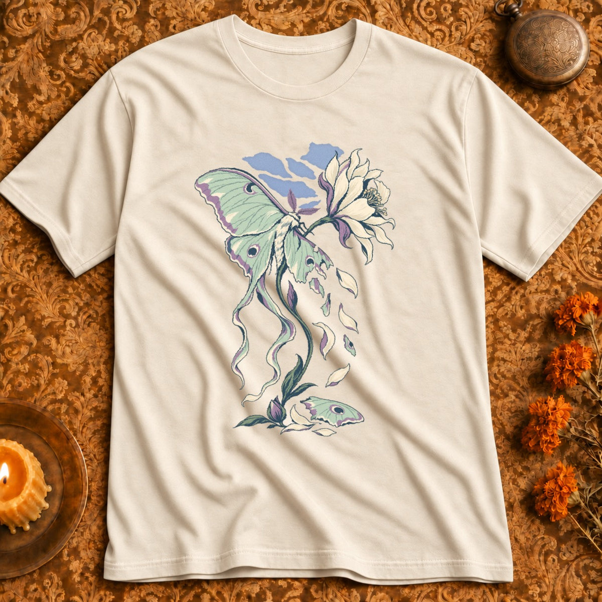 Light beige t-shirt with a green and purple luna moth and flower graphic.
