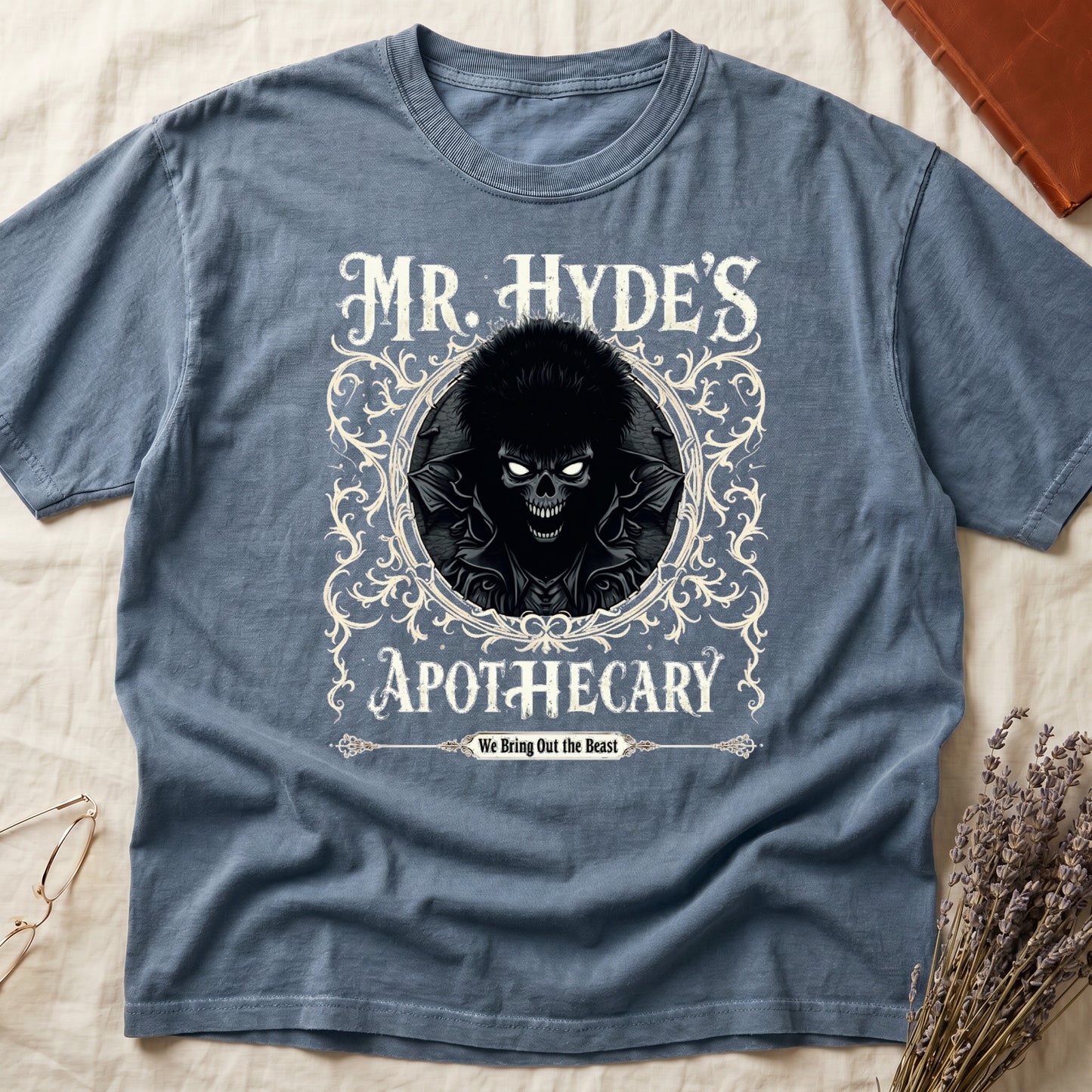 Espresso tee with ornate filigree frame, wild-haired skull figure, "MR. HYDE'S APOTECARY," "We Bring Out the Beast" below.
