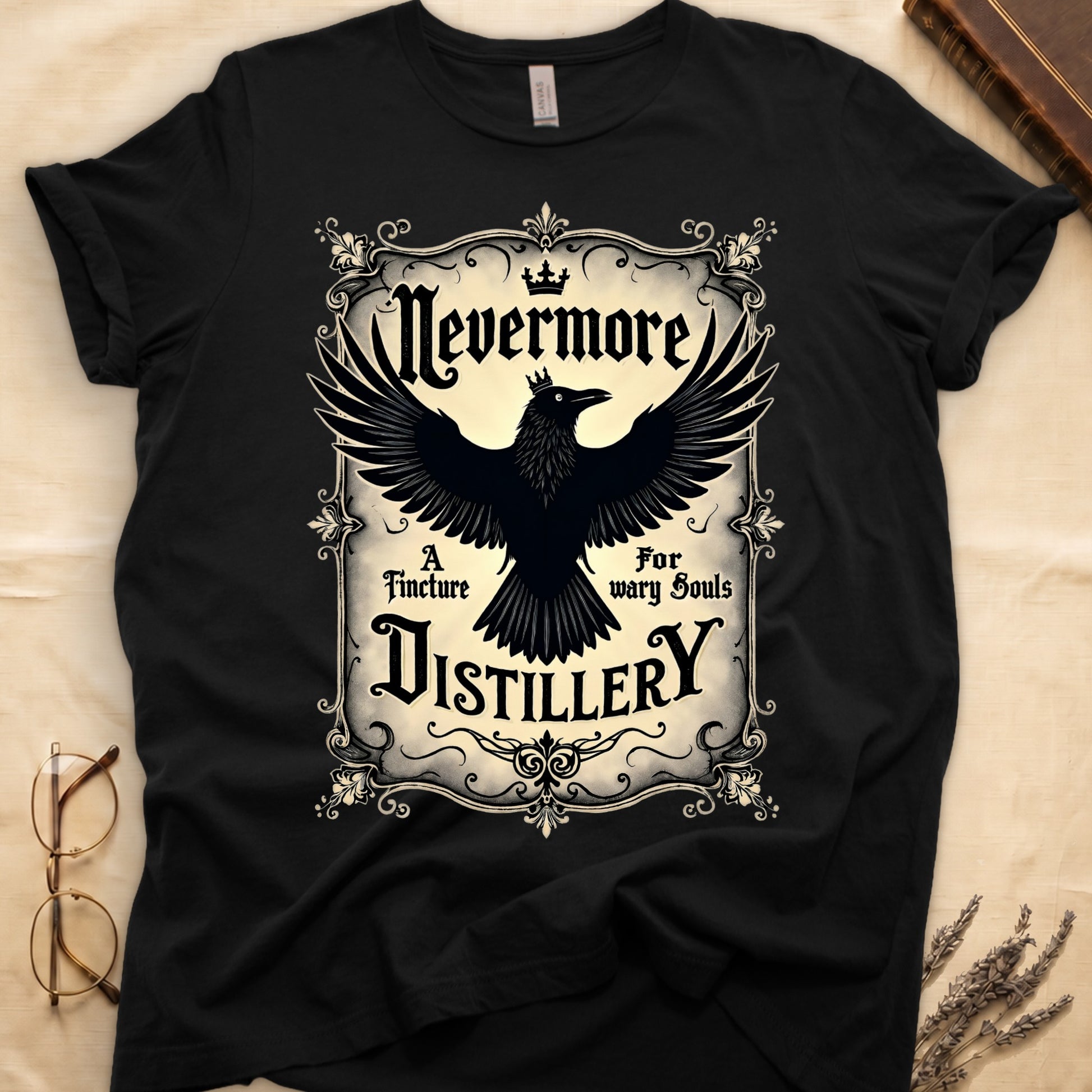 Black tee with antique label, crowned raven, blackletter "Nevermore" top, "A Tincture For wary Souls," "DISTILLERY" bottom.