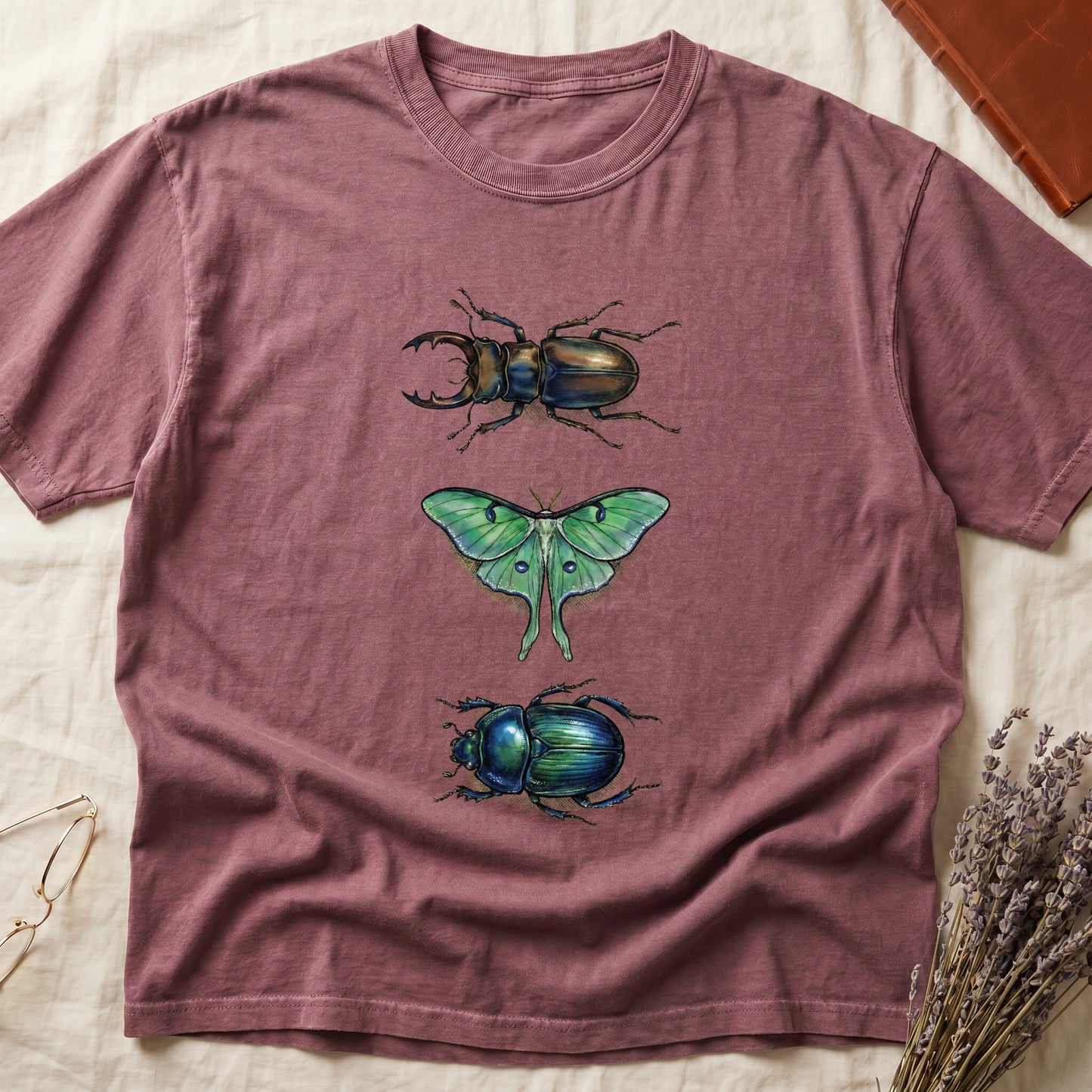 Black tee with three-panel Dark Rose-history plate: stag beetle, luna moth, scarab beetle in ink on yellow ground.