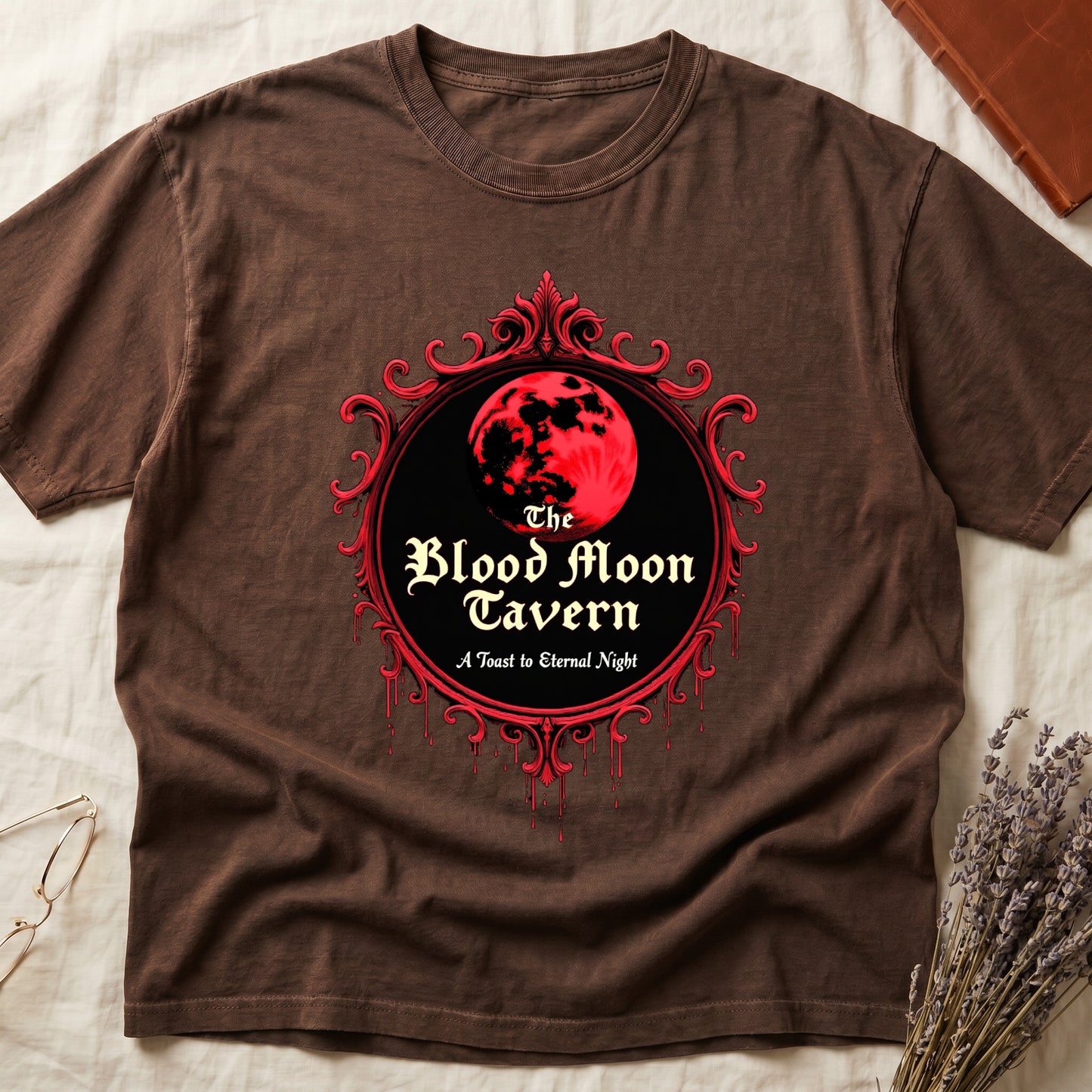 Espresso tee with red oval frame, blood-red moon, "The Blood Moon Tavern," "A Toast to Eternal Night," red drips below.