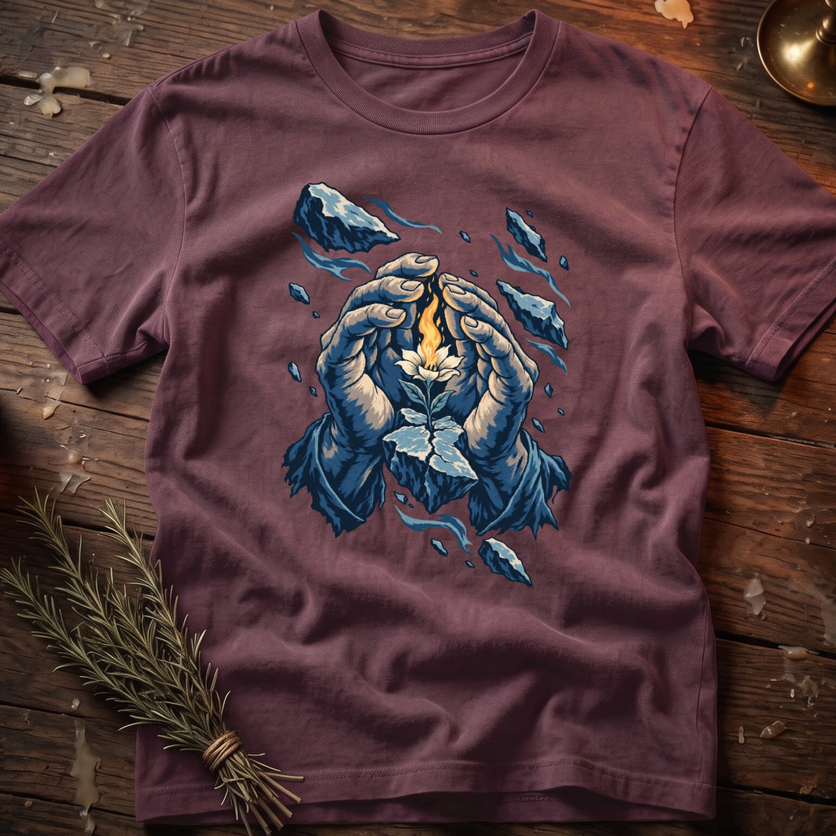 T-shirt with illustration of hands holding a blooming flower with fire and floating ice rocks.