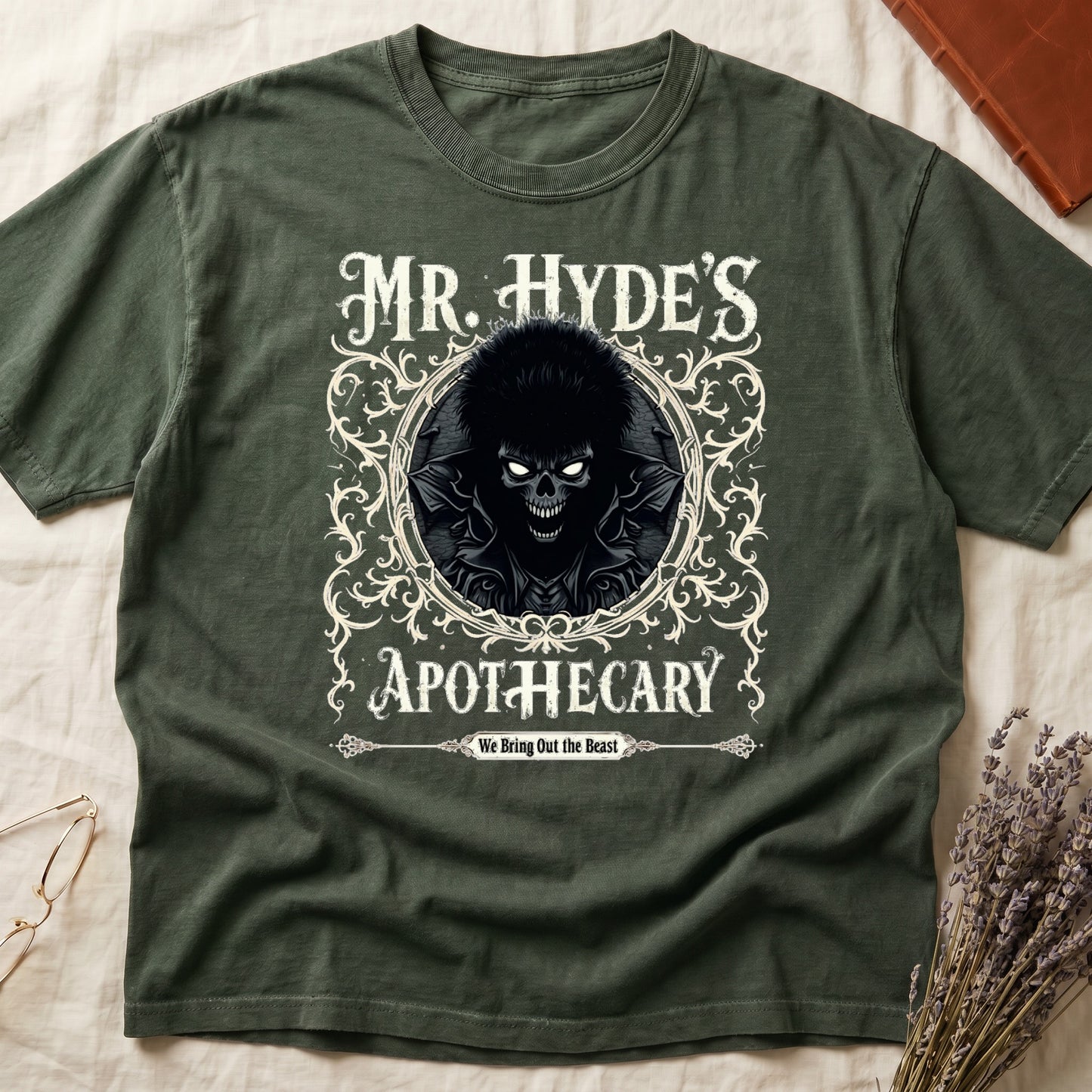 Dark Rose tee with ornate filigree frame, wild-haired skull figure, "MR. HYDE'S APOTECARY," "We Bring Out the Beast" below.