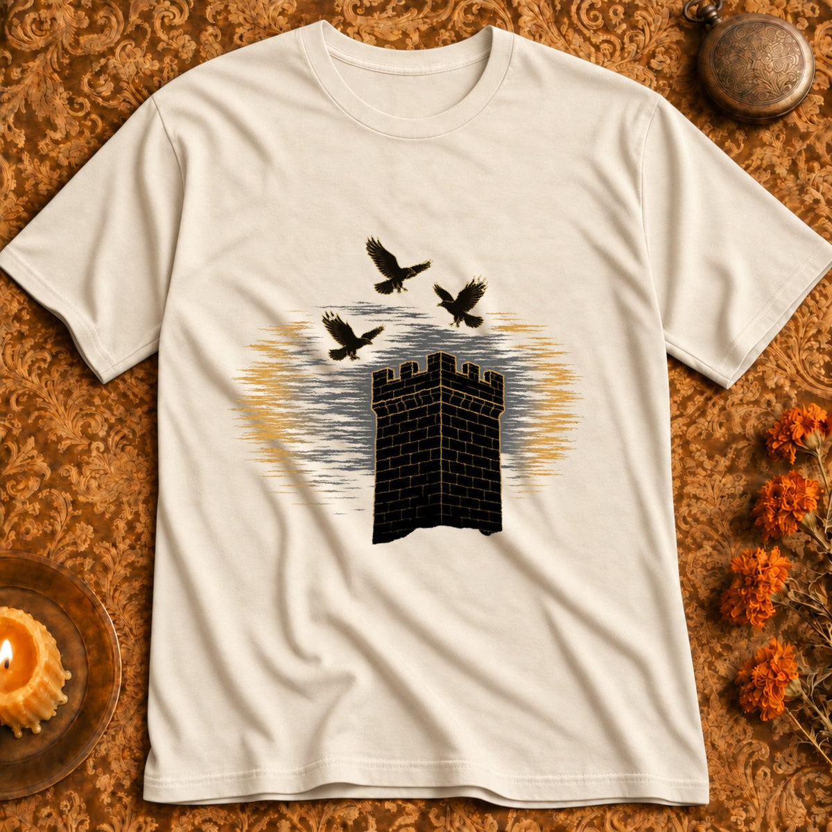 Cream t-shirt with black castle tower graphic and three black birds flying above.