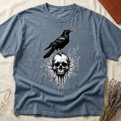 Blue Jean tee with raven silhouette on human skull, ink drips from jaw, bare branches behind, monochrome illustration.