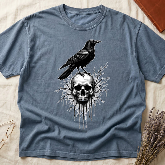 Blue Jean tee with raven silhouette on human skull, ink drips from jaw, bare branches behind, monochrome illustration.