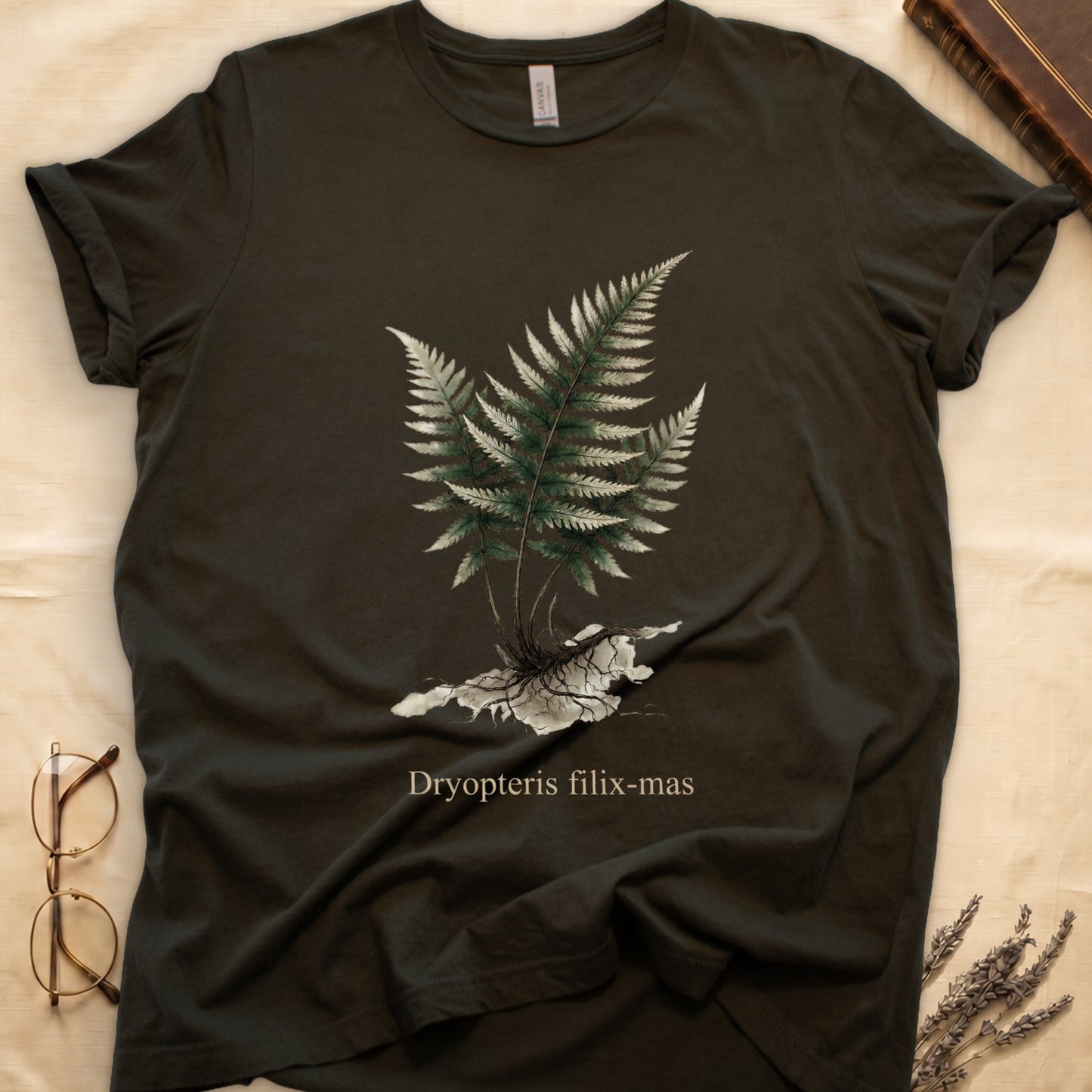 Military Green tee with Victorian fern illustration of Dryopteris filix-mas in greens with exposed root, italic Latin binomial below.