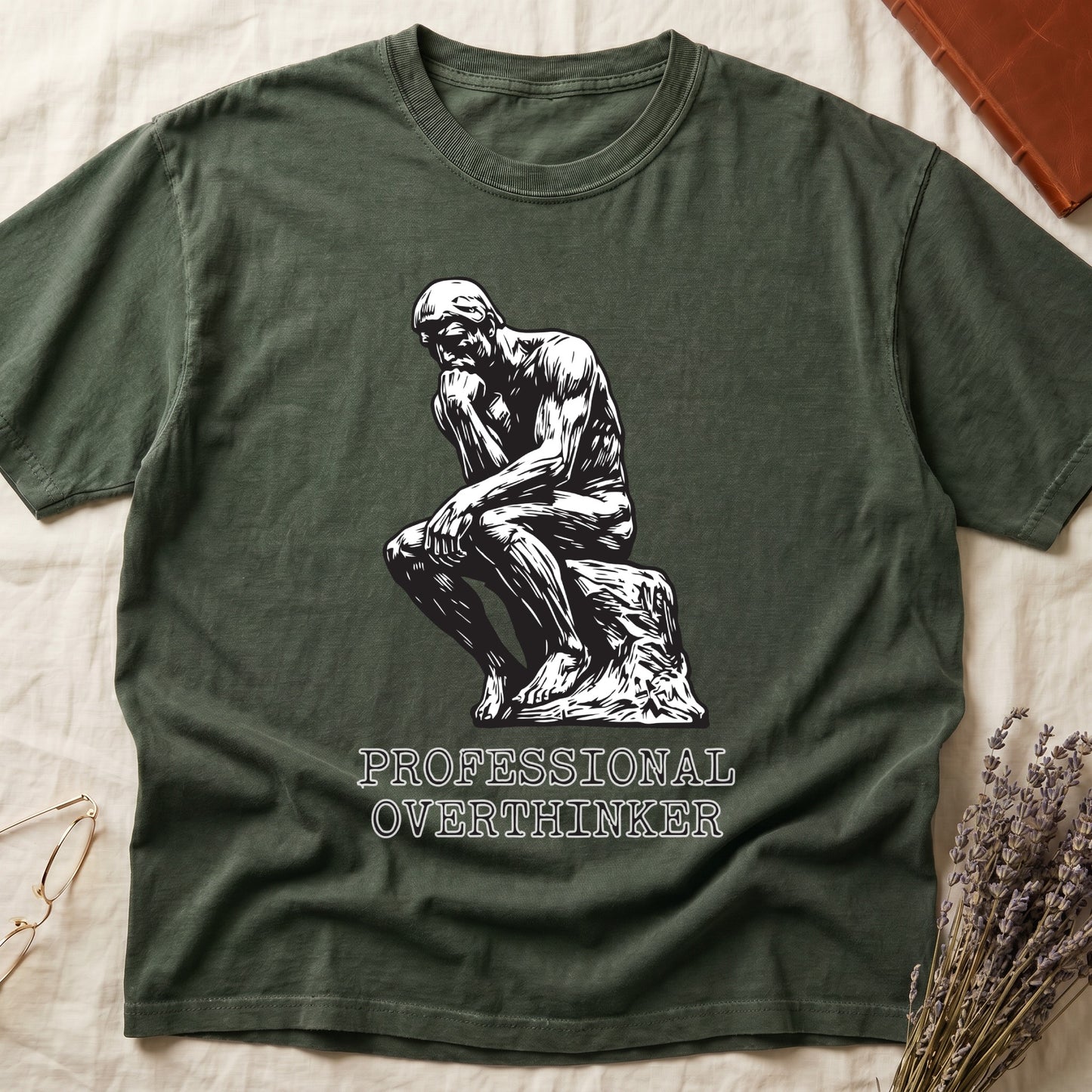 Green tee with monochrome rendering of Rodin's Thinker, "PROFESSIONAL OVERTHINKER" in serif capitals below.
