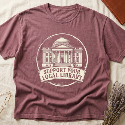Dark Rose tee with circular cream badge of a classical library building, "SUPPORT YOUR LOCAL LIBRARY" on a banner below.