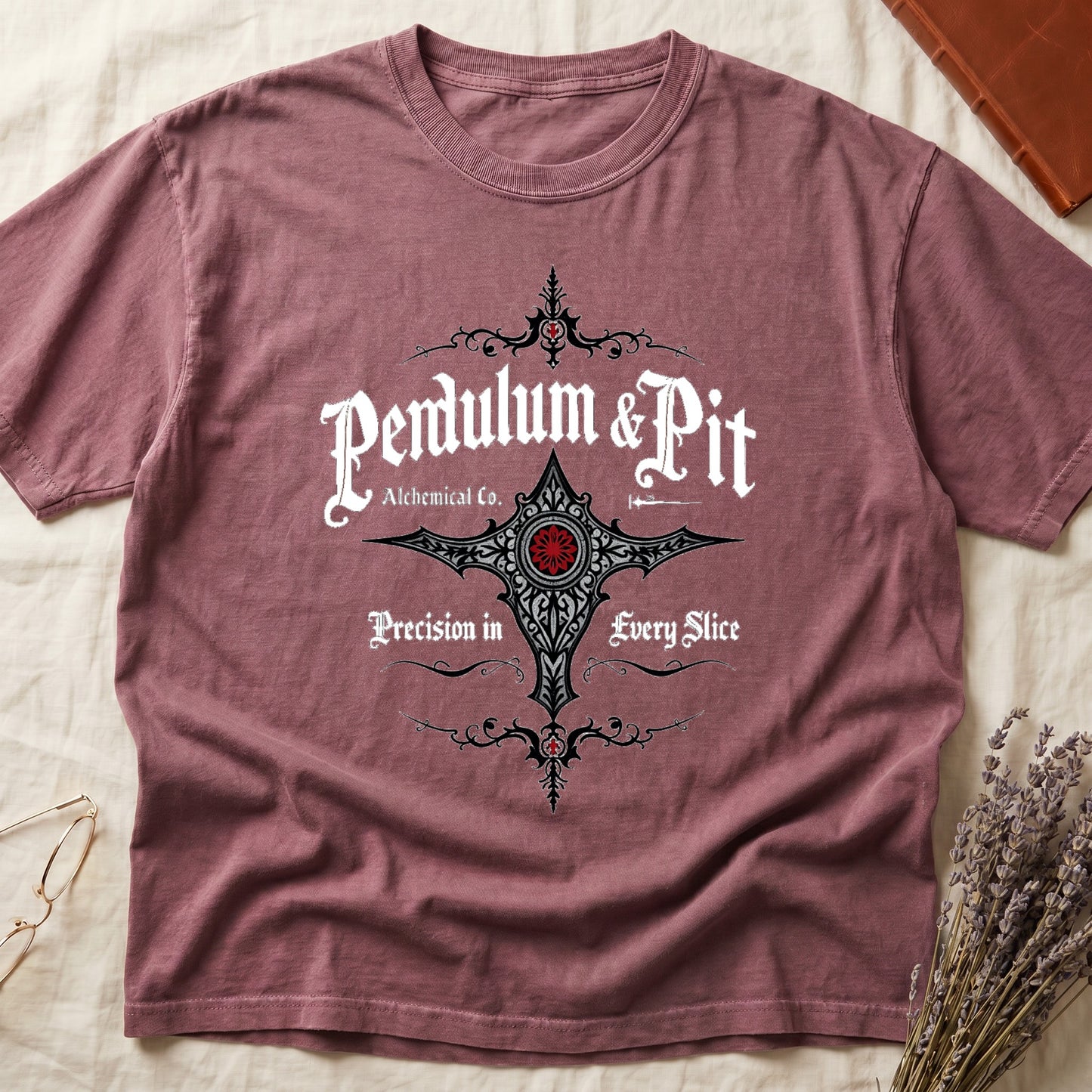 Dark Rose tee with white talismanic cross, "Pendulum & Pit Alchemical Co.," "Precision in Every Slice" banner ribbons.