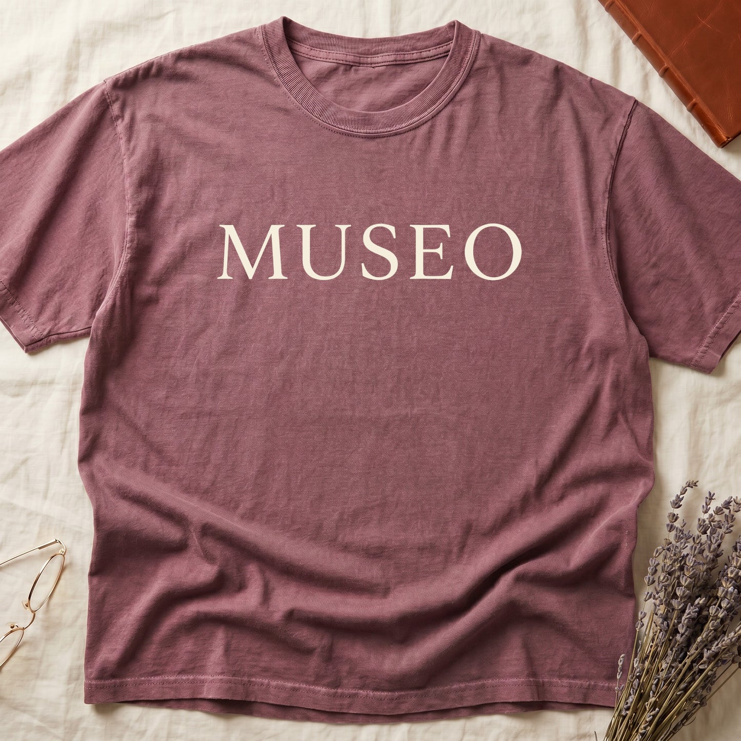 Dark Rose tee with "MUSEO" in oversized cream serif capitals, minimalist typographic design.