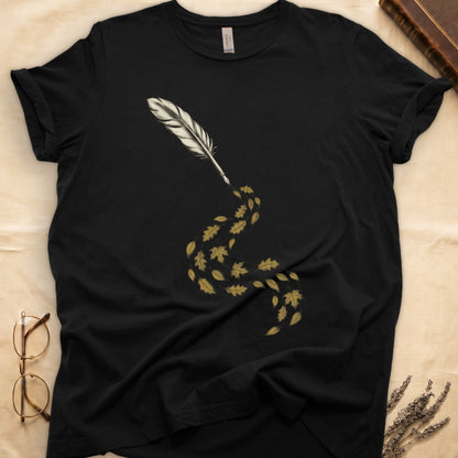 Black tee with antique quill pen in cream linework, oak and maple leaves cascading from the nib in gold and green.