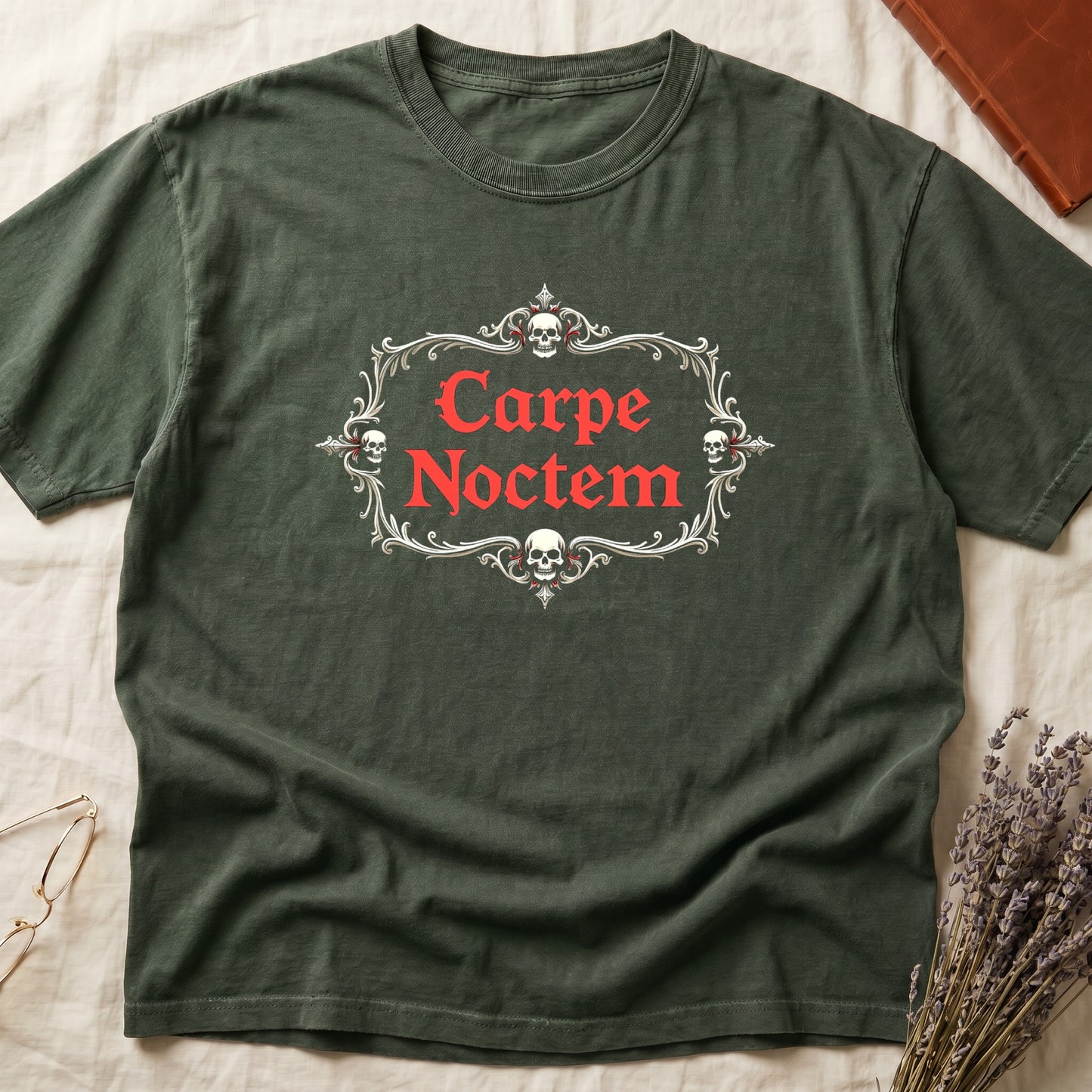 Green tee with silver filigree cartouche, crowned skull top and skull below, "Carpe Noctem" in deep-red blackletter inside.