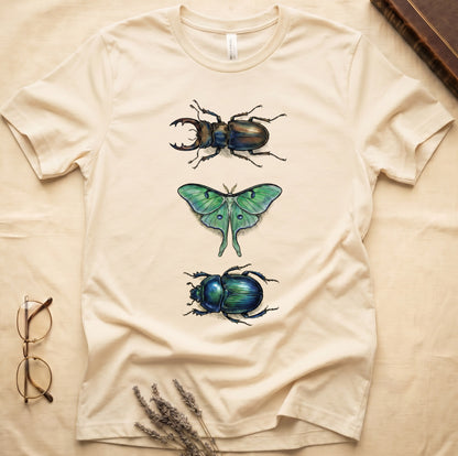 Black tee with three-panel Natural-history plate: stag beetle, luna moth, scarab beetle in ink on yellow ground.