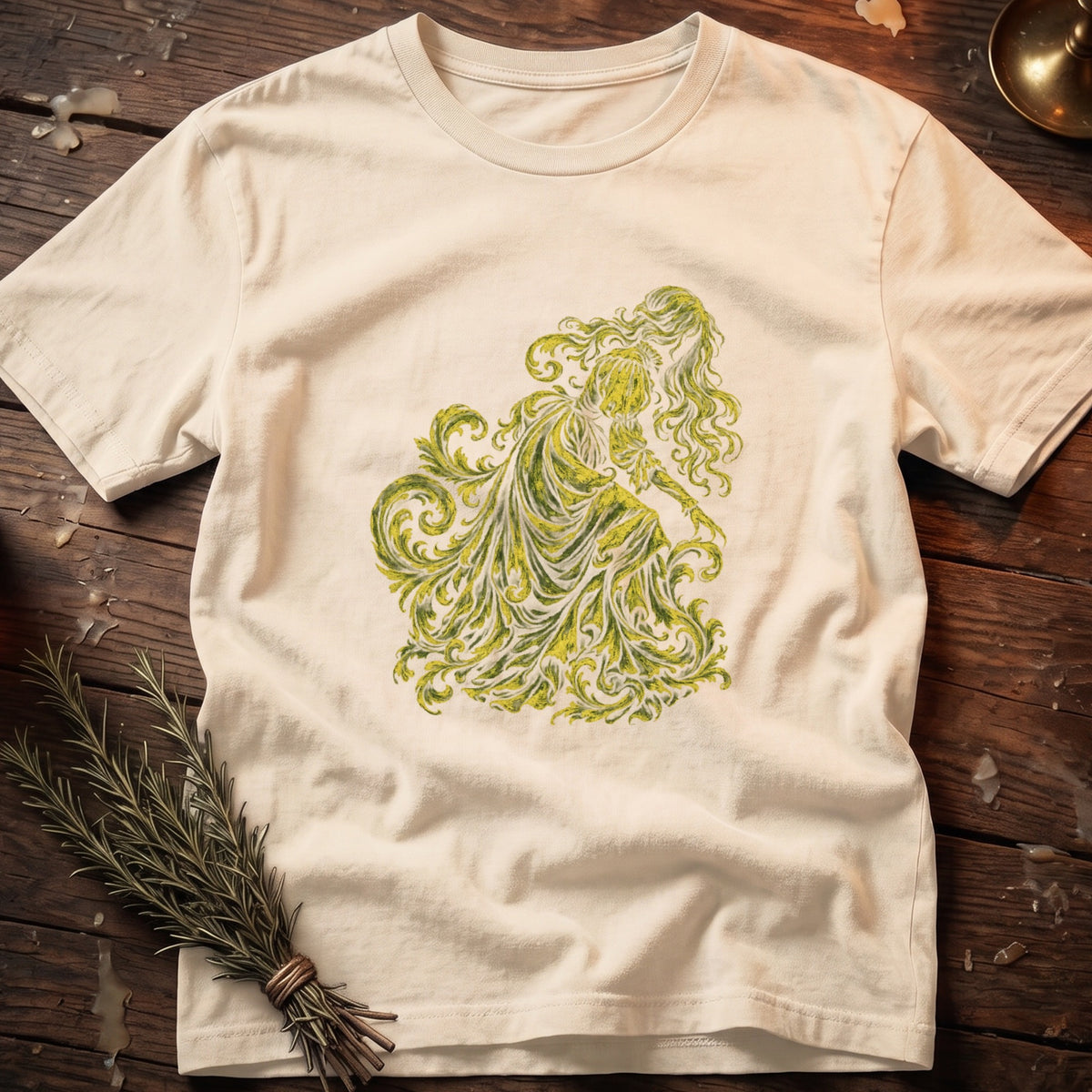 Cream t-shirt with a green and yellow ornate female figure graphic.