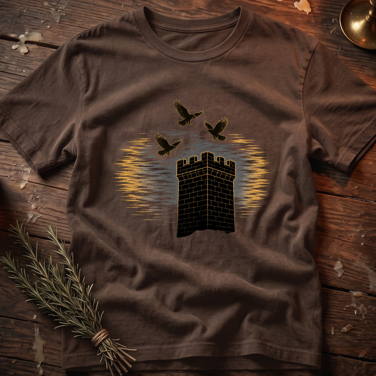 Brown t-shirt with graphic of a brick tower and three black birds flying.