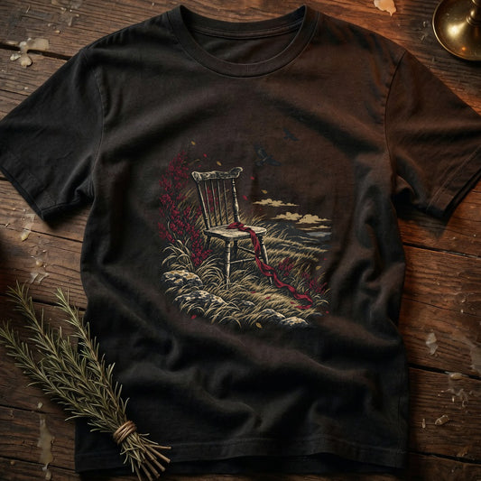 T-shirt with a dark t-shirt featuring a graphic of an empty chair on a grassy hill with red ribbon.