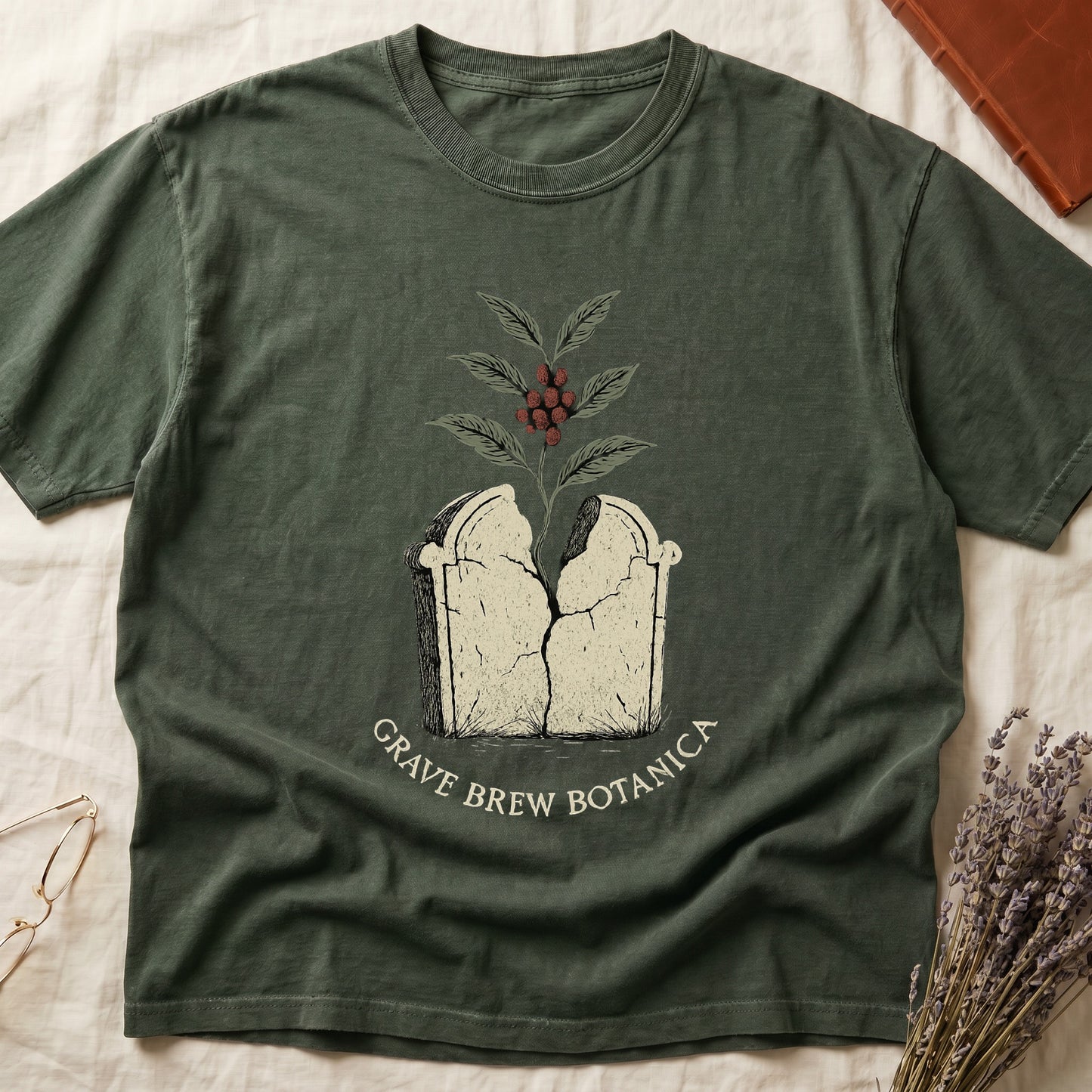 Green t-shirt with a cracked tombstone graphic and "Grave Brew Botanica" text.