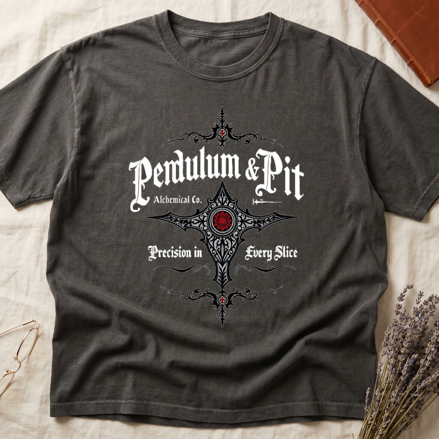 Pepper tee with white talismanic cross, "Pendulum & Pit Alchemical Co.," "Precision in Every Slice" banner ribbons.