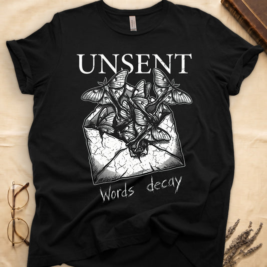 Black tee with 'UNSENT' in serif type, 'Words decay' brush text, luna moths from torn envelope in crosshatched ink
