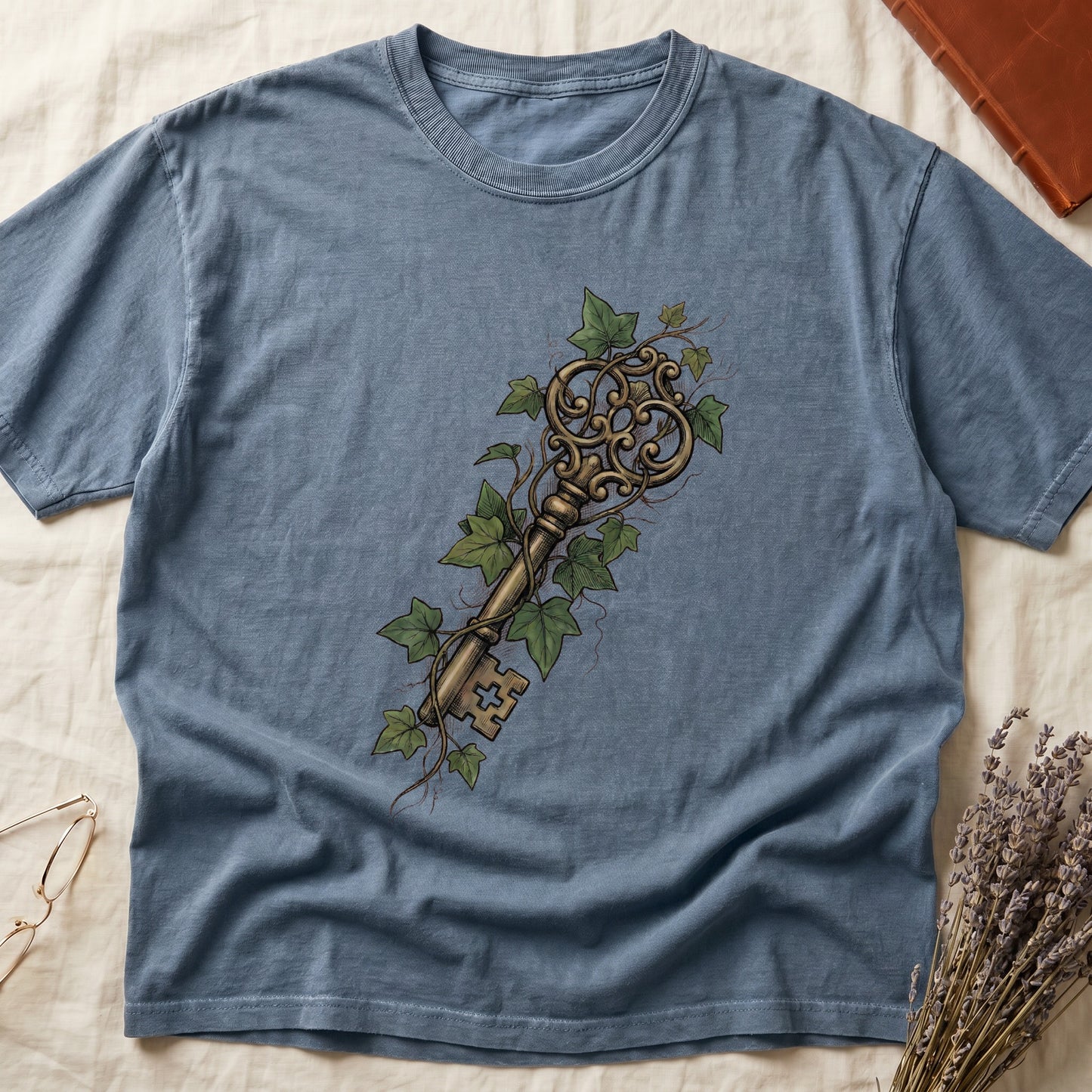 Blue Jean tee with ornate antique skeleton key in bronze, climbing English ivy in green on terracotta ground.