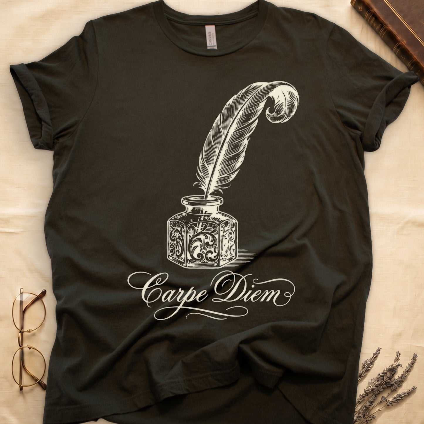 Military Green tee with ornate antique inkwell and quill pen in sepia linework, "Carpe Diem" in flowing cursive below.
