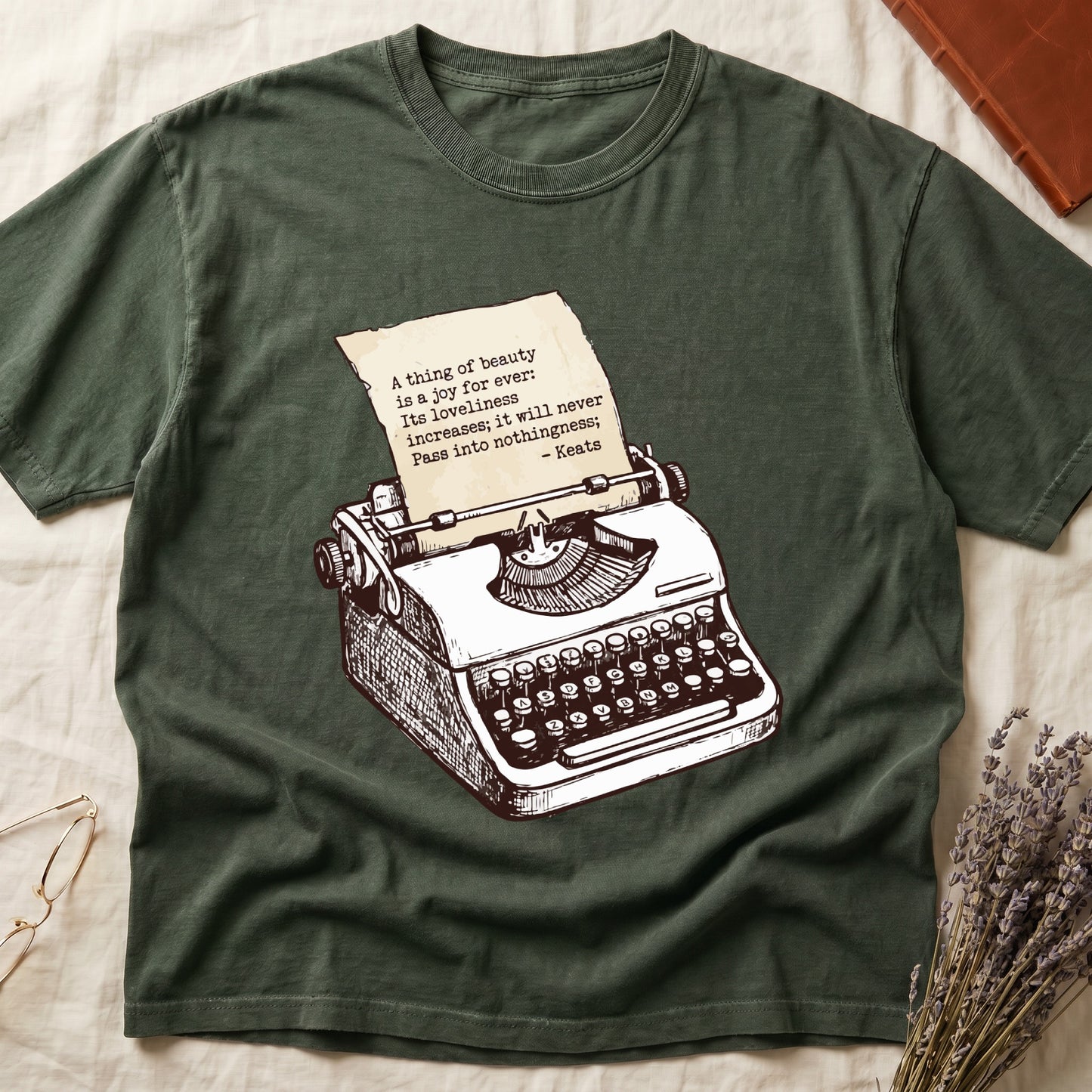 Green tee with vintage typewriter in cream linework, paper showing "A thing of beauty is a joy for ever" by Keats.