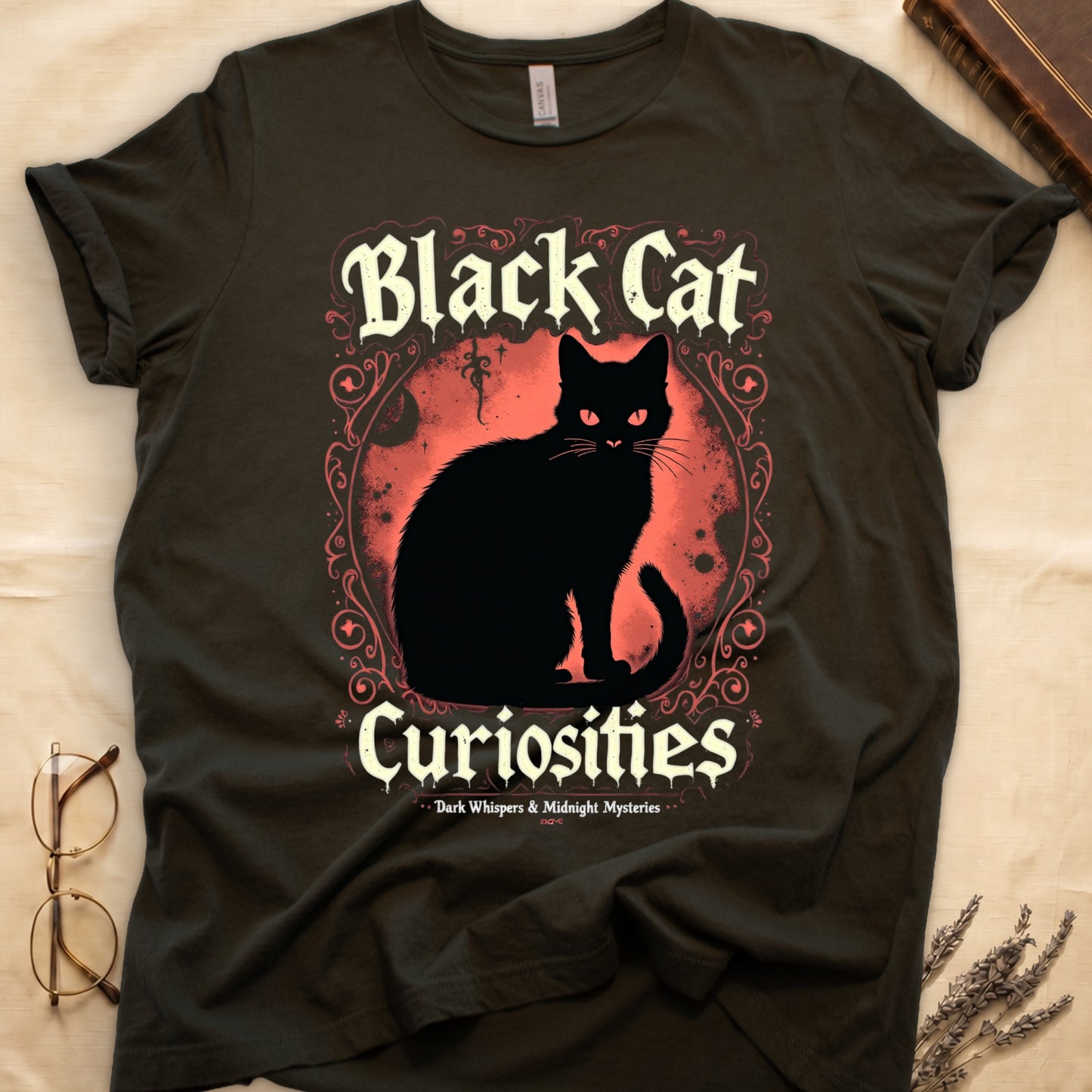 Military Green tee with black cat, red eyes, red-orange moon, "Black Cat Curiosities," "Dark Whispers & Midnight Mysteries."
