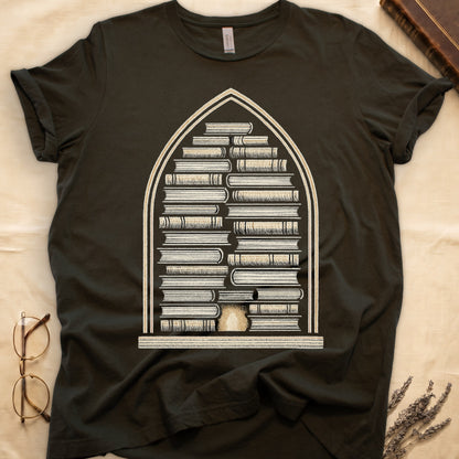 Military Green tee with gothic arch frame, columns of leather-bound books inside, sunburst medallion at base, cream engraved linework.