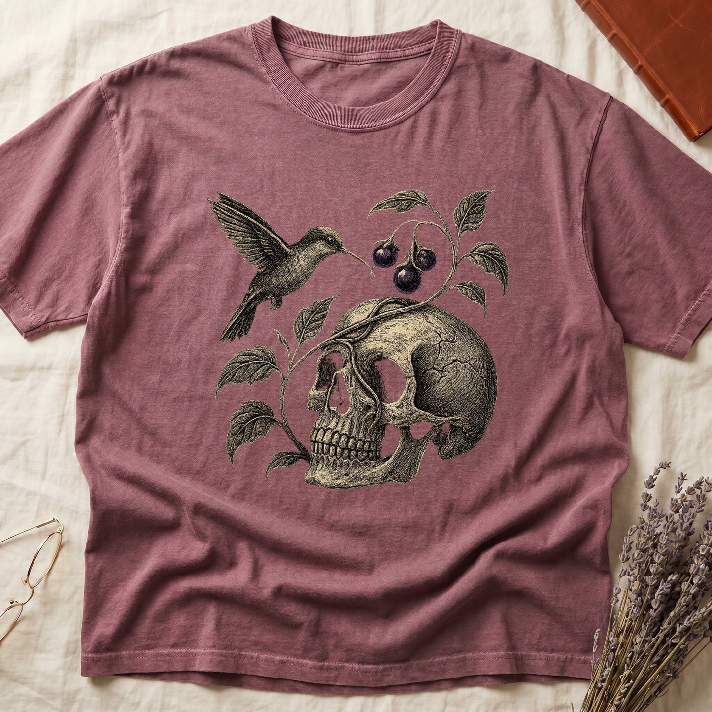 Dark Rose tee with sepia engraved skull, nightshade vine and dark-purple berries wrapping around, hummingbird at upper left.