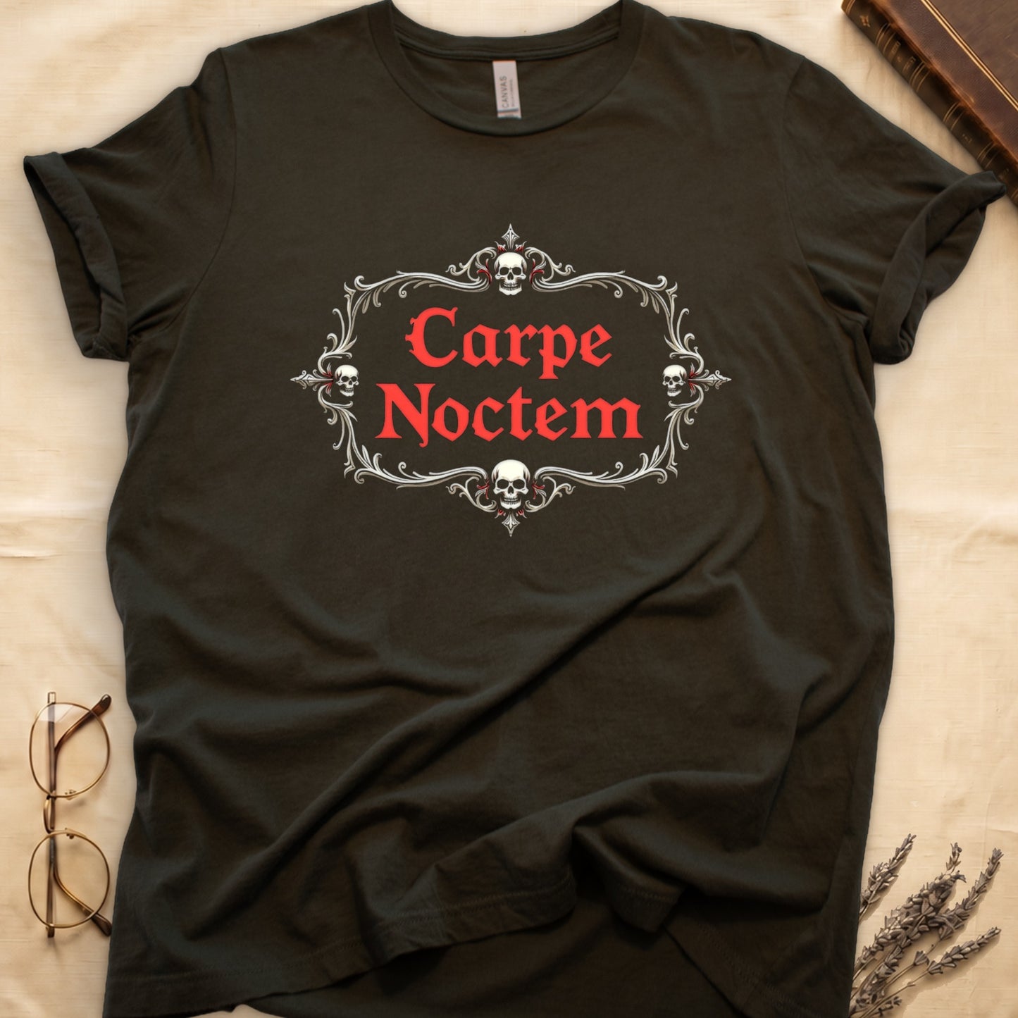 Military Green tee with silver filigree cartouche, crowned skull top and skull below, "Carpe Noctem" in deep-red blackletter inside.