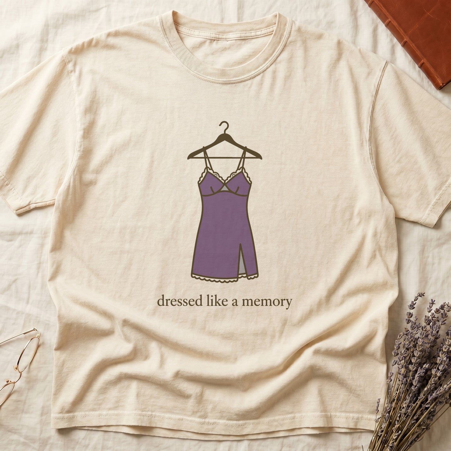 Ivory tee with dusty plum slip dress on cream hanger and "dressed like a memory" in lowercase cream serif below.