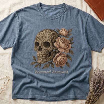 Blue Jean tee with filigree-engraved skull on left, peach-cream peonies on right, crossed bones below, "Botanical Boneyard."
